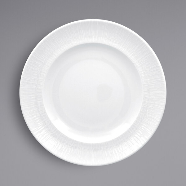 A white RAK Porcelain plate with a textured white rim.