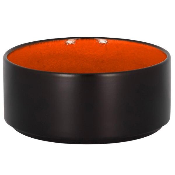A white bowl with a black and orange rim.