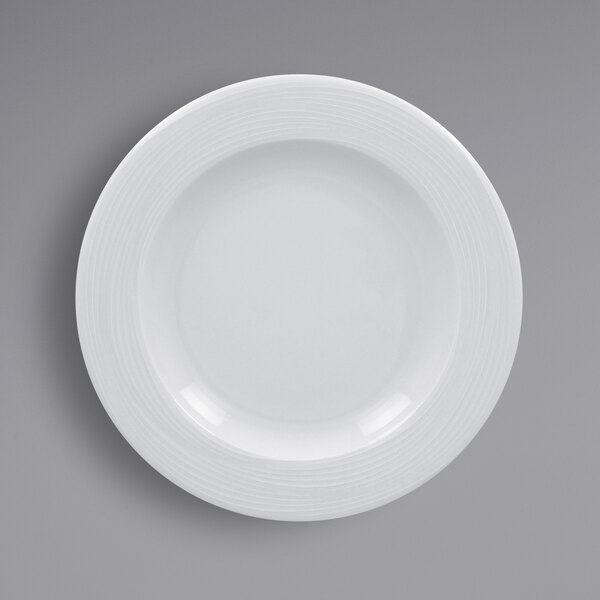 A RAK Porcelain white porcelain plate with a circular design on the rim.