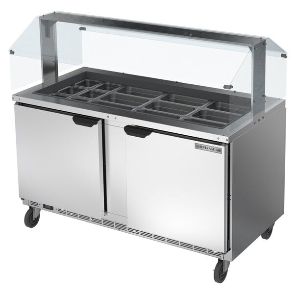 A Beverage-Air stainless steel sneeze guard on a cold food table.