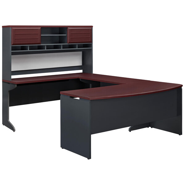 A Bridgeport U-shaped desk with hutch in cherry with gray accents and wire management slots.