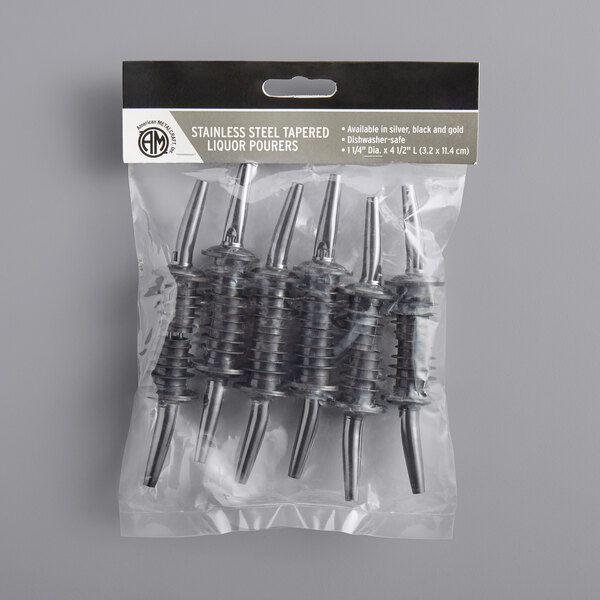 A package of 12 American Metalcraft black stainless steel liquor pourers on a table in a winery cellar.