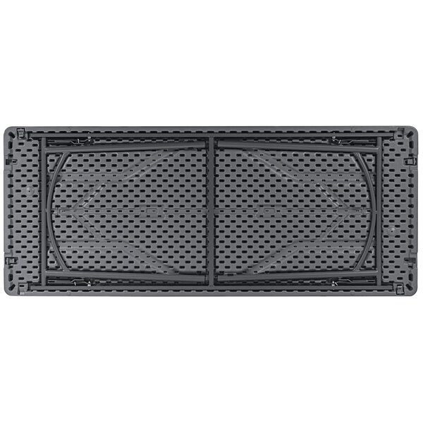 A close-up of a gray rectangular plastic surface with holes in it.