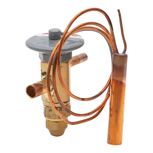 A close-up of a Continental Refrigerator copper expansion valve attached to a copper pipe.