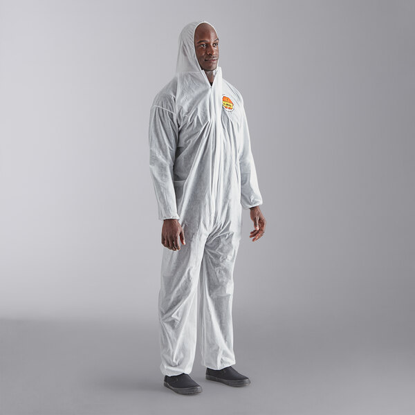 A man in white Cordova polypropylene coveralls with elastic wrists and a hood.