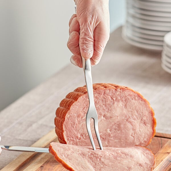 a person cutting meat with a fork