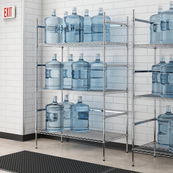 A Regency chrome wire shelving unit holding water jugs.