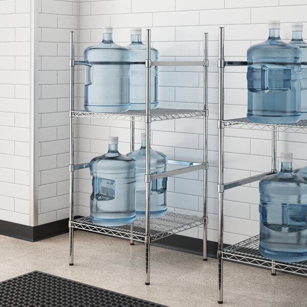 A Regency metal wire rack holding water jugs.