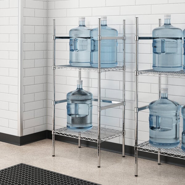 A chrome wire shelving unit with 2 shelves holding water jugs.