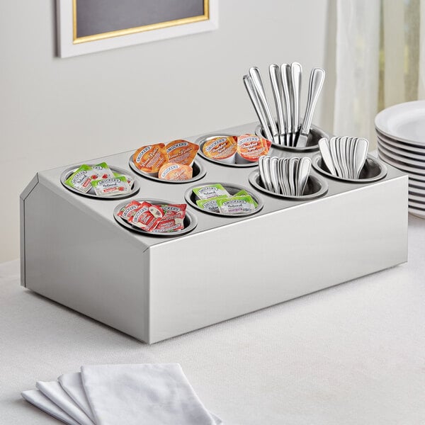 A stainless steel flatware organizer with silverware in it.