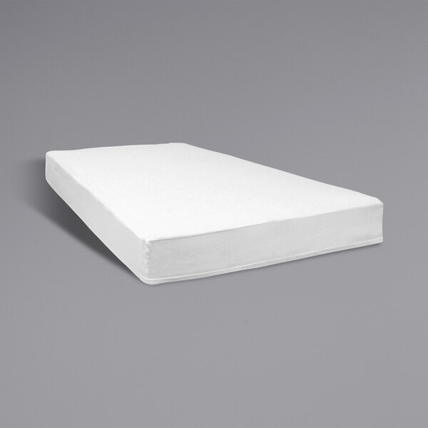 A white Foundations SafeFit fitted mattress for a compact playard.