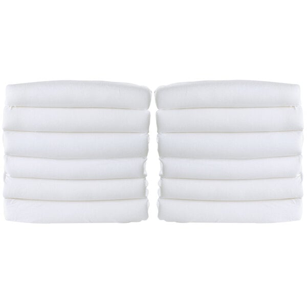A stack of white Foundations SnugFresh playard covers.