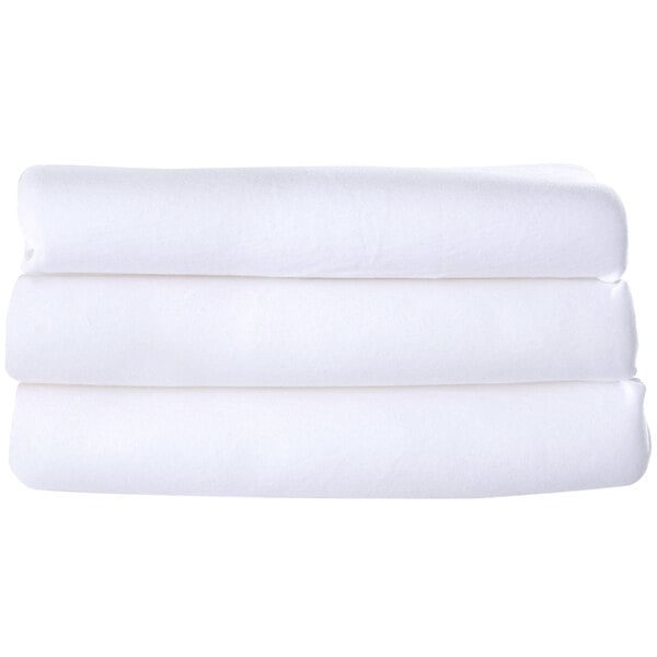 A stack of white compact washable microfiber playard covers.