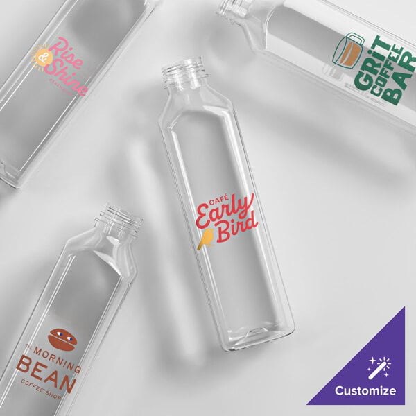 A set of clear, tall square PET juice bottles with customizable printed labels.