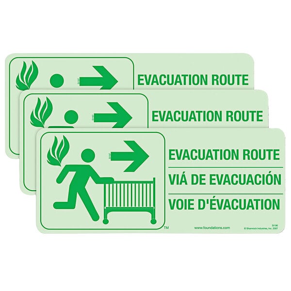 a green sign with a person running with a crib and arrow