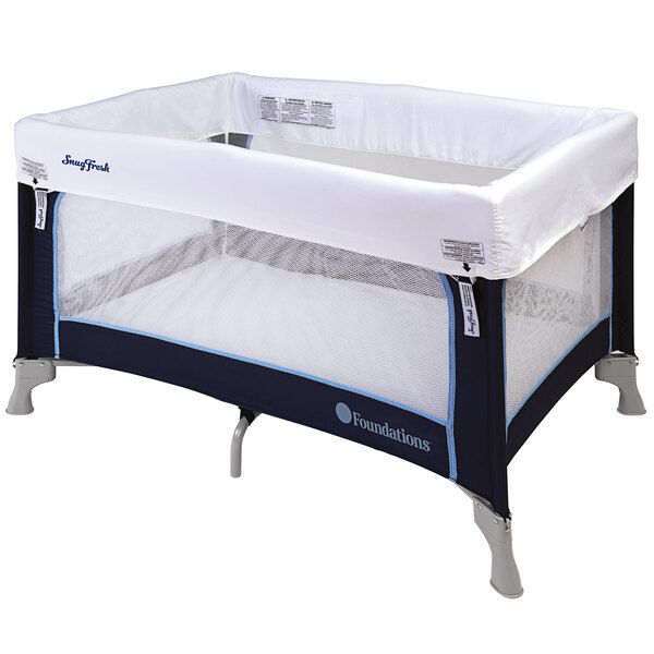 A white and blue Foundations Celebrity playard set up with mattress and cover.