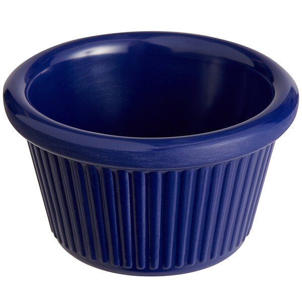 A blue fluted melamine ramekin on a counter.