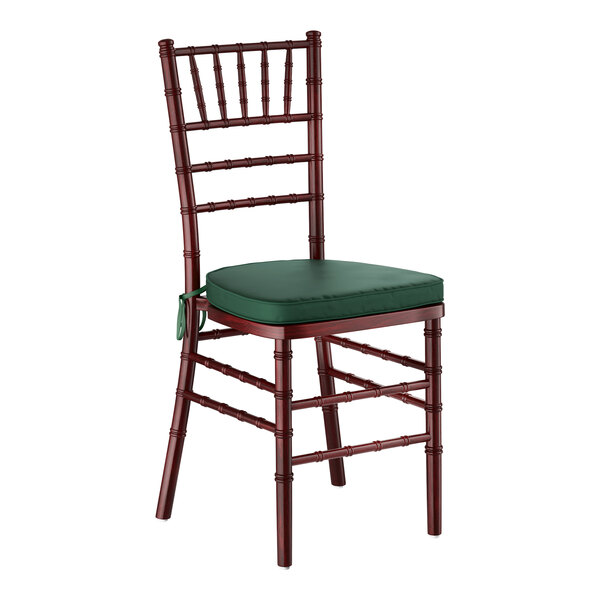 A mahogany wood Chiavari chair with a green cushion.