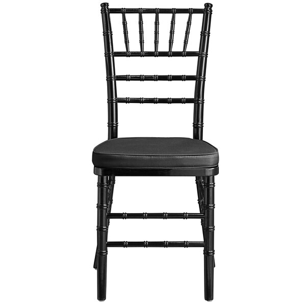 A Lancaster Table & Seating black wood Chiavari chair with black cushion.