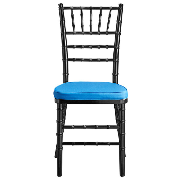 A black Lancaster Table & Seating Chiavari chair with a blue cushion.