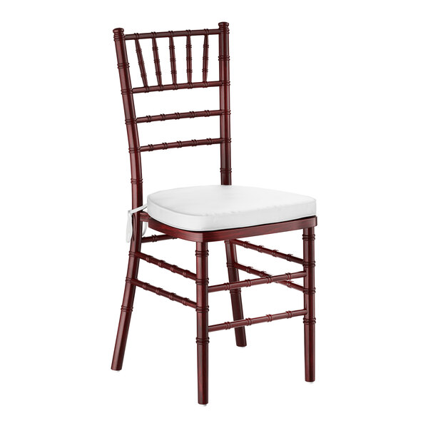 A mahogany wood Chiavari chair with a white cushion.