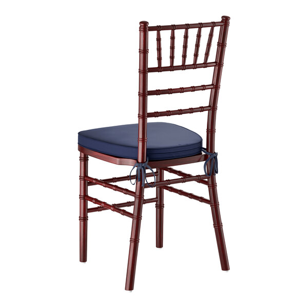A mahogany wood Chiavari chair with a navy blue cushion.