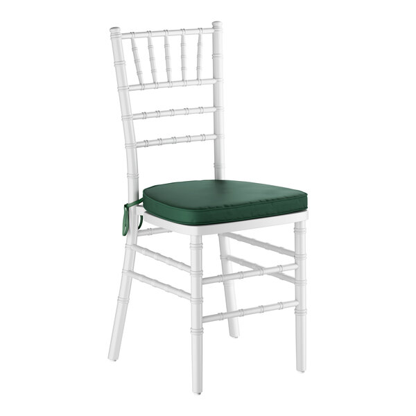 A white wood Chiavari chair with a green cushion.
