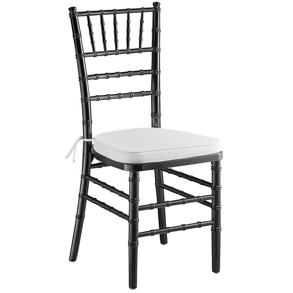 A black Lancaster Table & Seating Chiavari chair with a white cushion.