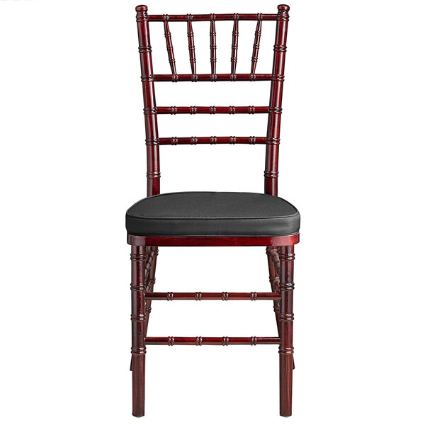 A Lancaster Table & Seating mahogany Chiavari chair with black cushion.