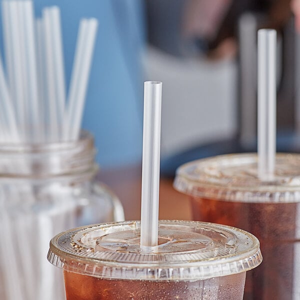 Two plastic cups of iced coffee with Choice giant translucent straws.