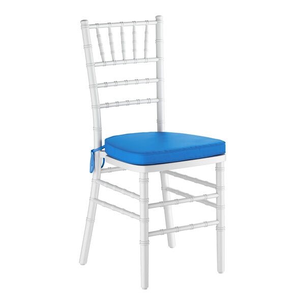 A white wood Chiavari chair with a blue seat cushion.