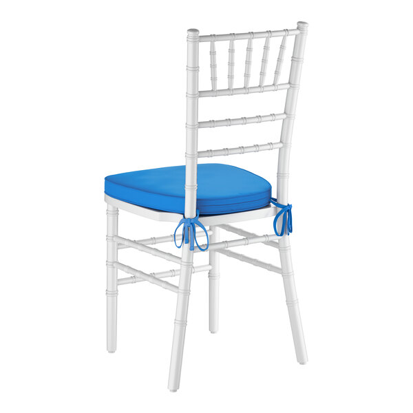 A white wood Chiavari chair with a blue cushion tied to the seat.