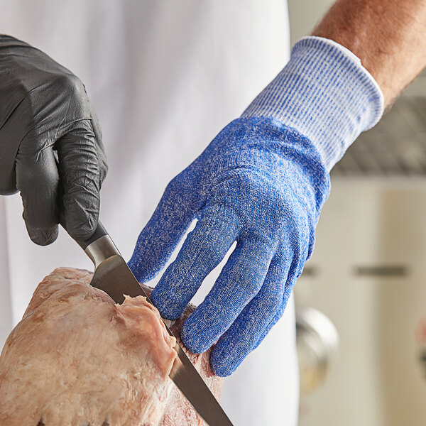 a person cutting meat with a knife