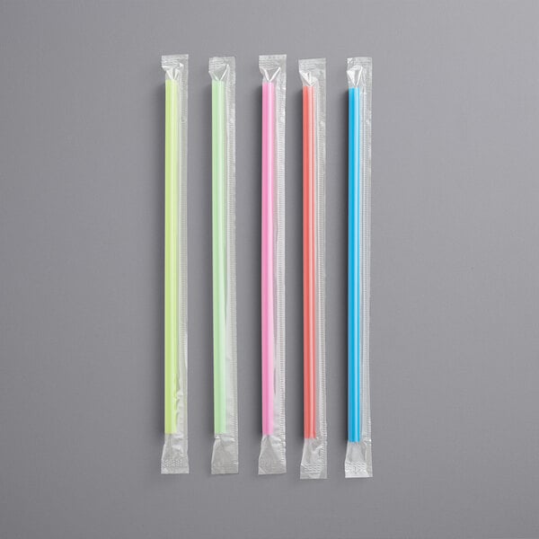 a group of straws in plastic wrappers