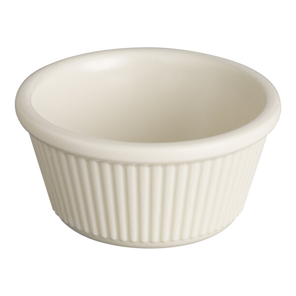 A small, bone white fluted melamine ramekin.