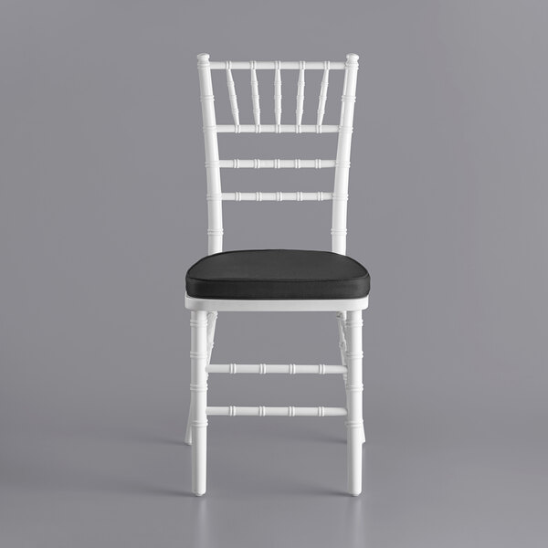 A white Lancaster Table & Seating Chiavari chair with a black cushion.
