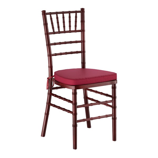A mahogany wood Chiavari chair with a wine red cushion.