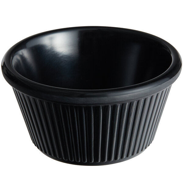 A black fluted Acopa melamine ramekin with a white background.