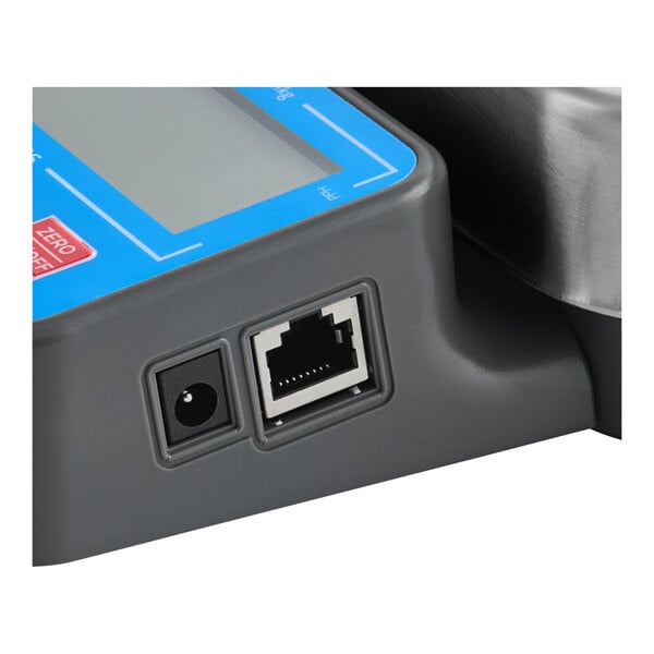 A digital receiving and portion scale with a built-in handle, showing its display panel and connection ports.