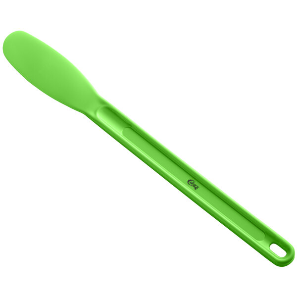 a green spoon on a white background