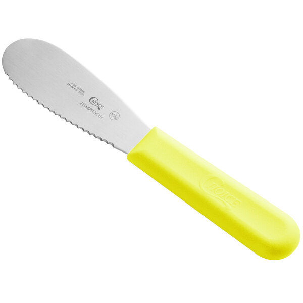 A stainless steel sandwich spreader with a neon yellow handle.