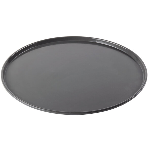A black Chicago Metallic pre-seasoned aluminum pizza pan on a white counter.