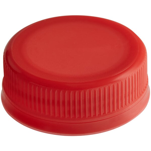 A close-up of a red plastic bottle cap with a lid on top.
