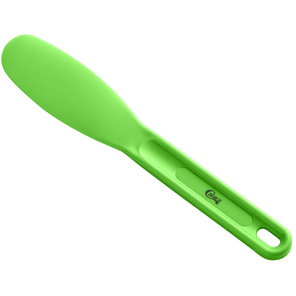 A Choice green plastic sandwich spreader with a handle.