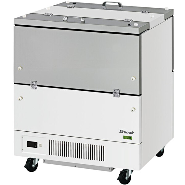 A white Turbo Air milk cooler with wheels.