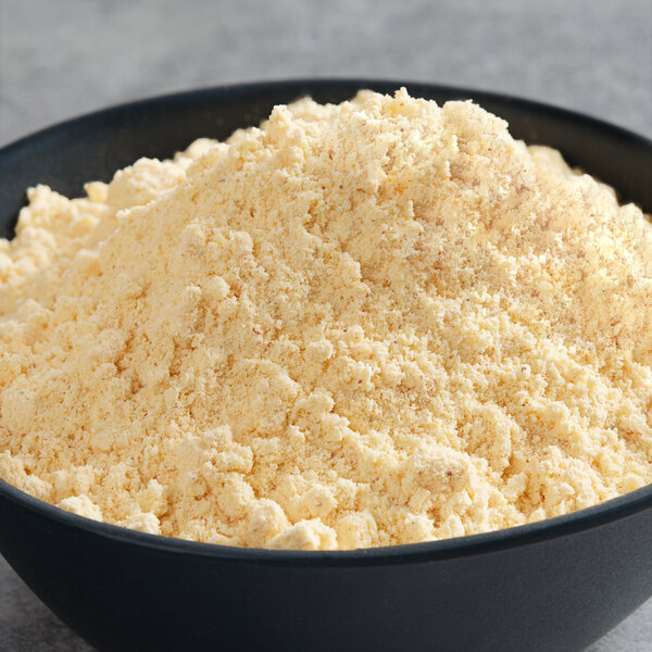 A bowl of Zatarain's Seasoned Fish Fri breading mix on a table with a white background.