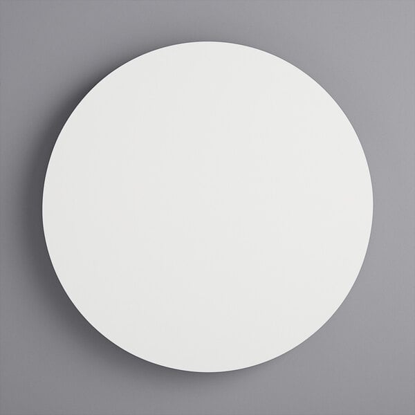 A white circular wood cake board.