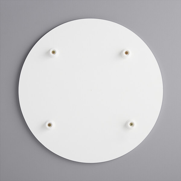 A white circular melamine-coated wood cake board with feet and screws.