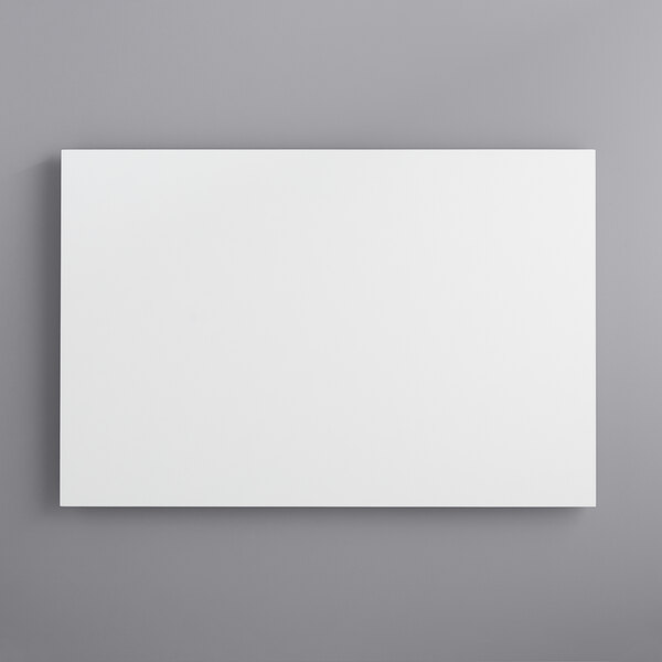 A white rectangular melamine-coated wood cake board.