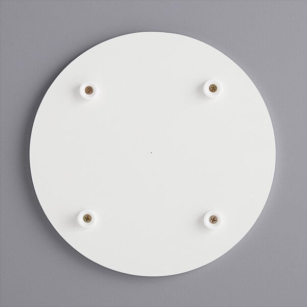 A white circular melamine-coated wood cake board with feet.